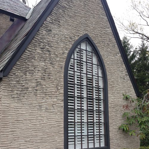 Exterior facade of brick home with plantation shutters